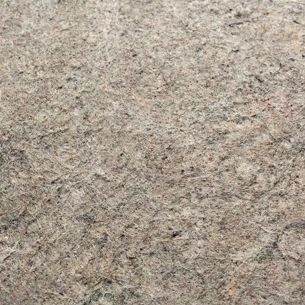 Lemieux et Cie Premium Felted Rug Pad in warm neutral tones, dense textured surface detail, close-up view of low-profile pad.