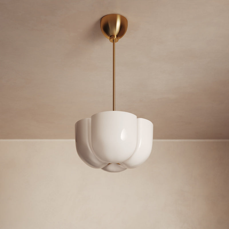 Lemieux et Cie Cheverny Pendant with sculptural white scalloped shade on slim brass rod, ceiling-mounted in soft neutral plaster room.