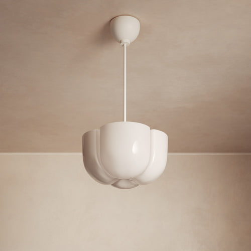Lemieux et Cie Cheverny Pendant in ivory white with sculptural scalloped shade, suspended from a slim rod against neutral plaster ceiling and walls.