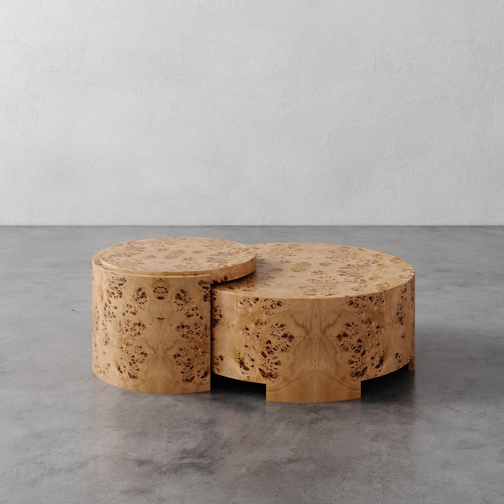 Lemieux et Cie Rondel Bunching Cocktail Table in blonde mappa burl veneer, paired drum-form coffee tables on concrete floor against neutral plaster walls.