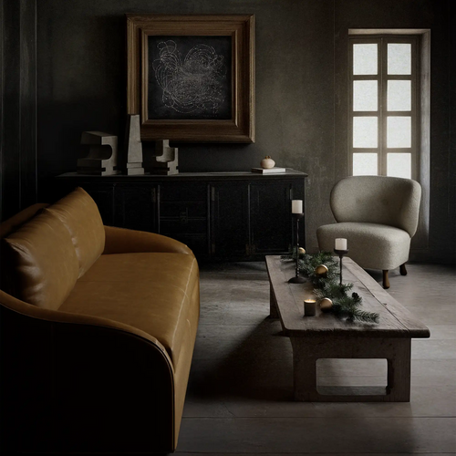 Lemieux Et Cie Brown Rousseau Leather Sofa, Lemieux Et Cie Tourenne Chair, Lemieux Et Cie Achille Candle Holder Collection, Lemieux Et Cie La Structure Sculptures, and Lemieux Et Cie Les Étoiles Limited Edition Art Print in a dark living room.