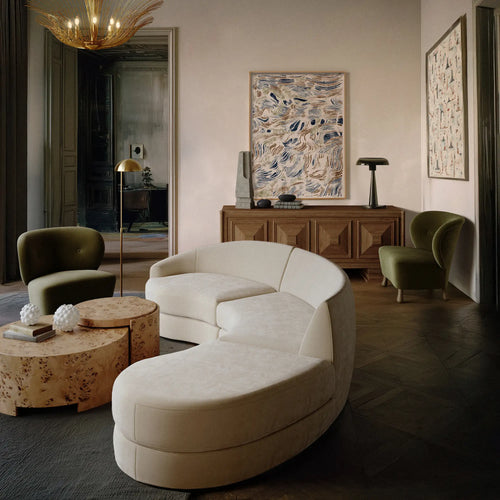 Lemieux et Cie Rondel Bunching Cocktail Table in blonde mappa burl, drum-shaped coffee table styled in a neutral sitting room with dark wood floors.