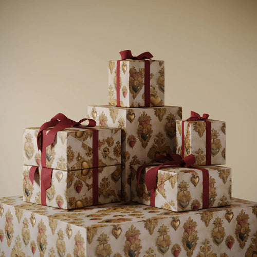 Stack of gifts wrapped in Lemieux et Cie premium wrapping paper: Sacred Heart fancy gift wrapping influenced by French devotional art from the 18th century