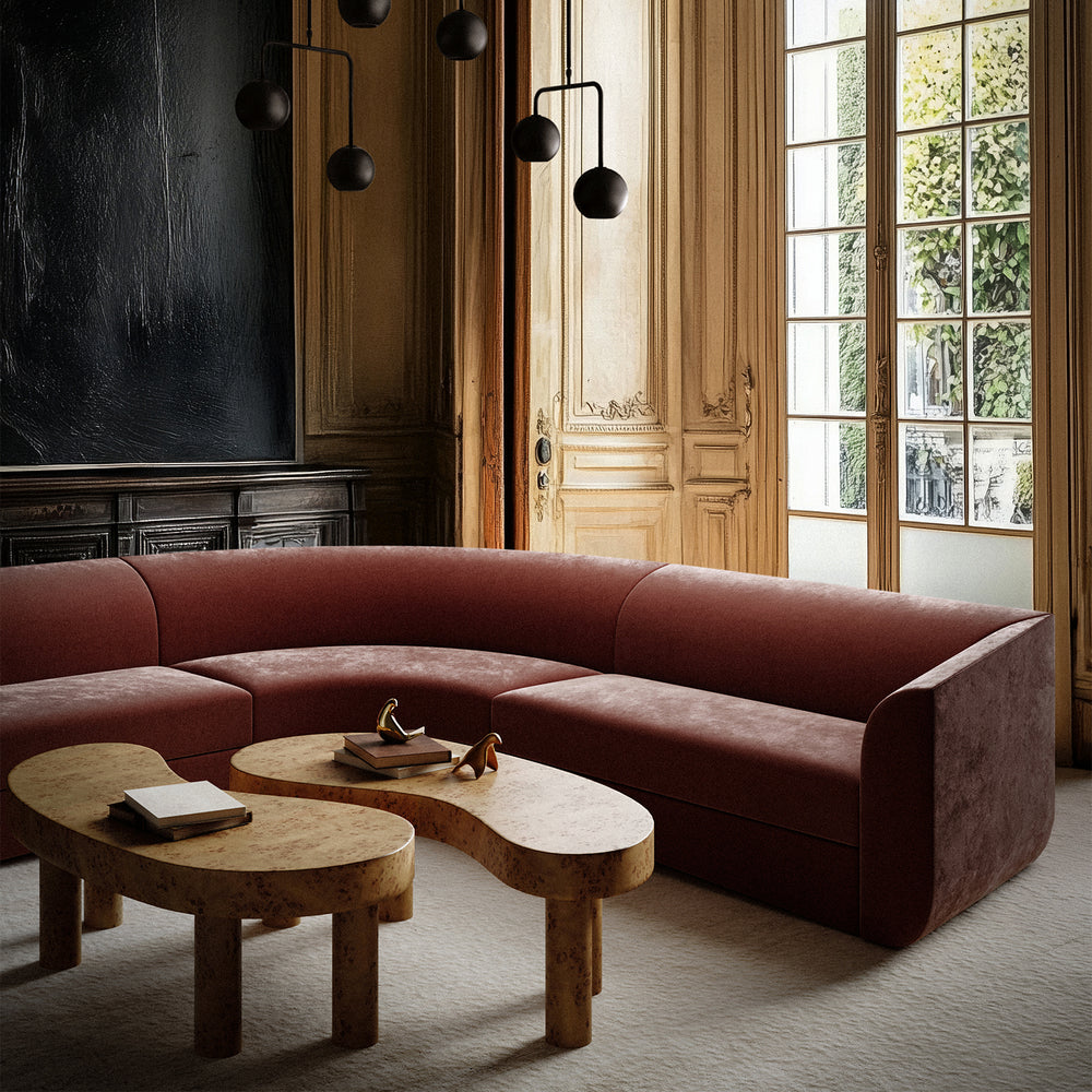 Lemieux et Cie Brenne Burl Coffee Table in Mappa burl veneer, rounded organic form styled in a wood-paneled sitting room with tall French doors.