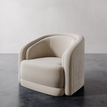 Lemieux et Cie Valence Swivel Chair in ivory, sculptural lounge chair with rounded arms and low-profile form, on polished concrete floor.