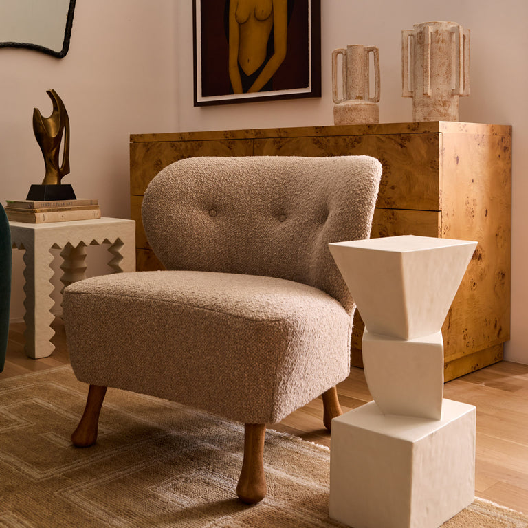 Lemieux et Cie Tourenne Chair in neutral bouclé with sculptural turned legs, lounge chair styled in a curated sitting room with wood floors and warm light.