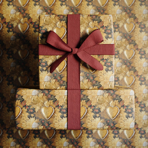 Lemieux et Cie Victorian Locket fancy gift wrapping that draws from 19th-century sentimental jewelry of heart-shaped lockets. A romantic and elegant gift wrap paper with floral motifs.