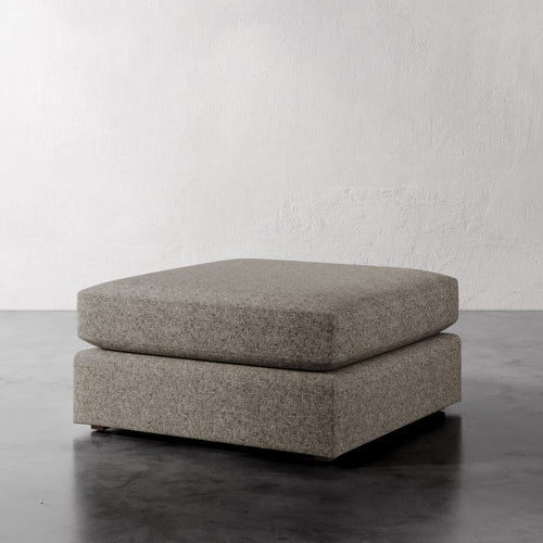 Lemieux Et Cie Chanaux Ottoman Gray ottoman on a dark surface with a light gray background