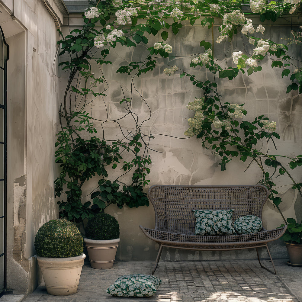Lemieux et Cie Jagger Woven 65" Love Seat, outdoor loveseat with curved frame and woven back, styled on tiled patio with flowering vines and planters.