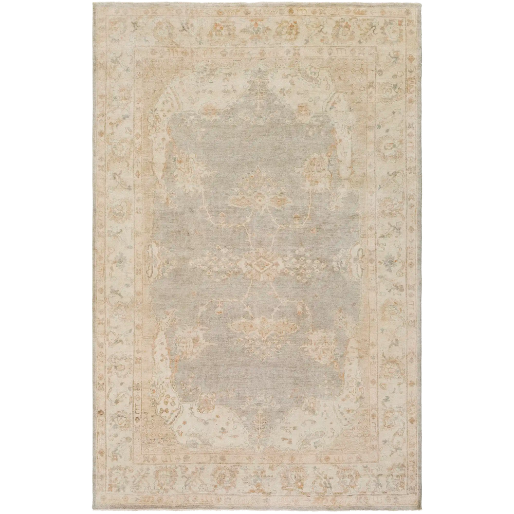 Lemieux et Cie Blanchet handmade wool rug in soft gray and warm neutral tones with border detail, shown on white studio backdrop