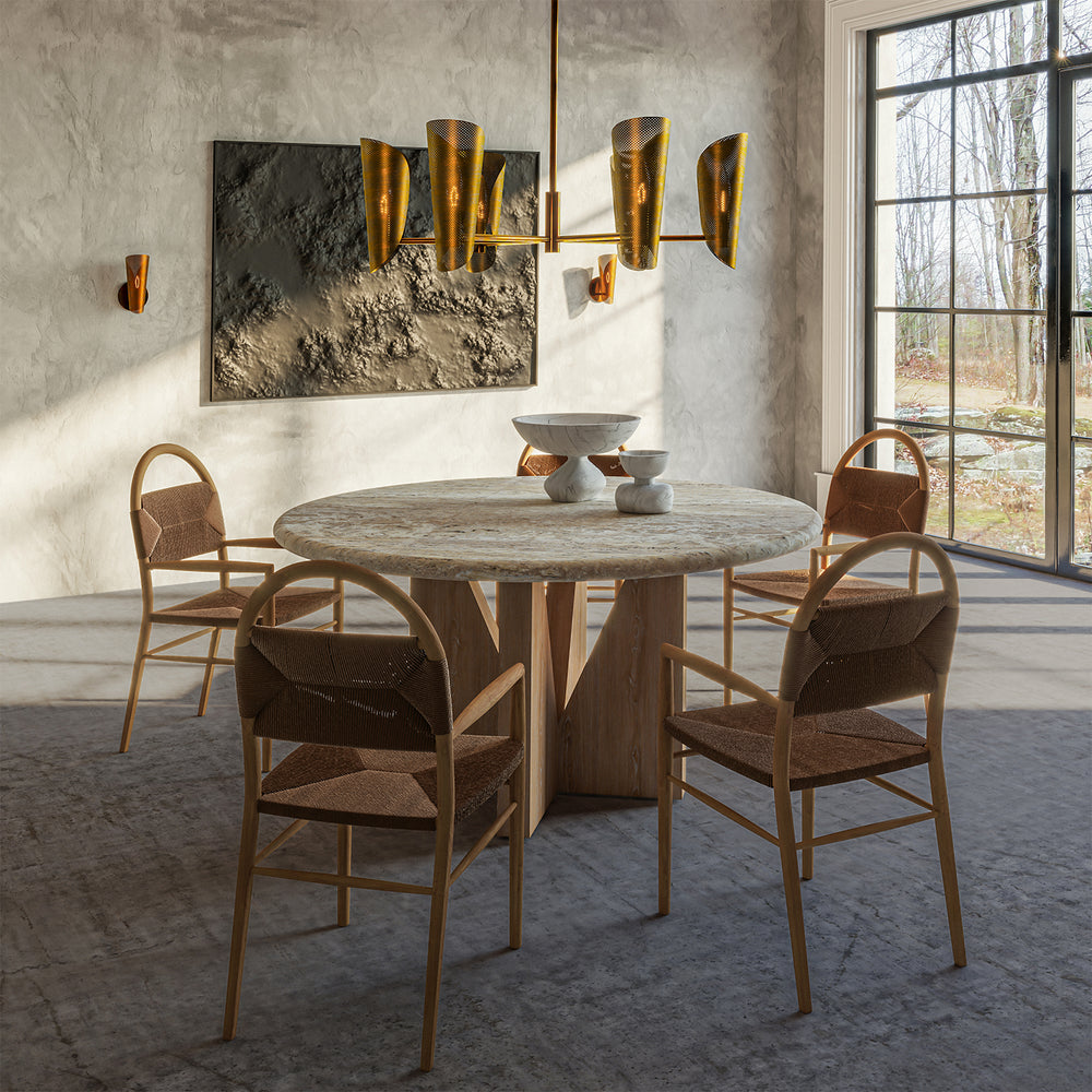 Lemieux et Cie Plivot 6 Light Large Chandelier, a luxury lighting fixture above the Elysées Dining Table with Pernelle Dining Arm Chairs and two Plivot Single Sconces.