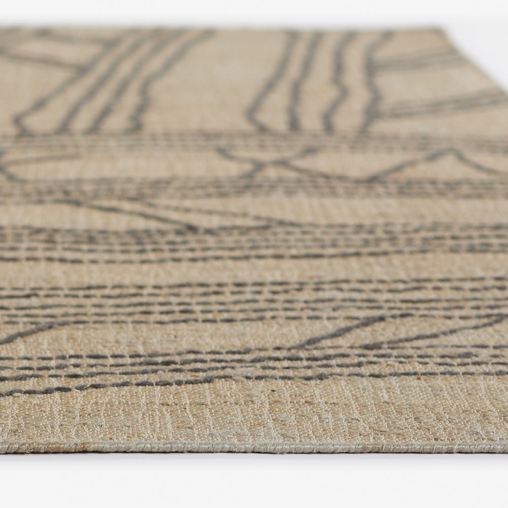 Lemieux et Cie rug in natural with dark geometric lines, close detail showing woven texture and low-profile edge on white backdrop.