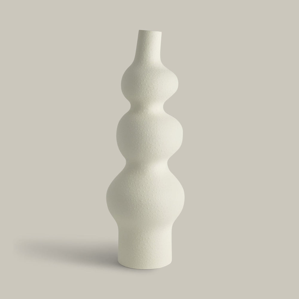 Lemieux et Cie Pasteur Vase in matte white, sculptural vase with stacked organic curves and narrow neck, shown on neutral studio backdrop.
