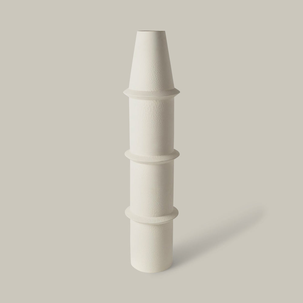 Lemieux et Cie Panisse Vase in matte white ceramic, tiered columnar form with textured surface, shown on neutral studio backdrop.