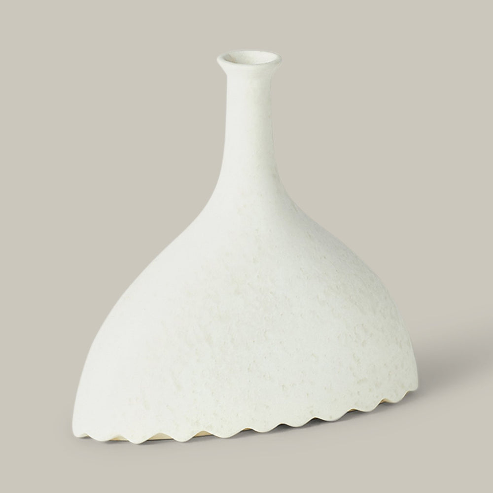 Lemieux et Cie Noelle Geometric Vase in white ceramic, sculptural bottle form with fluted base and slender neck, shown on neutral studio backdrop.