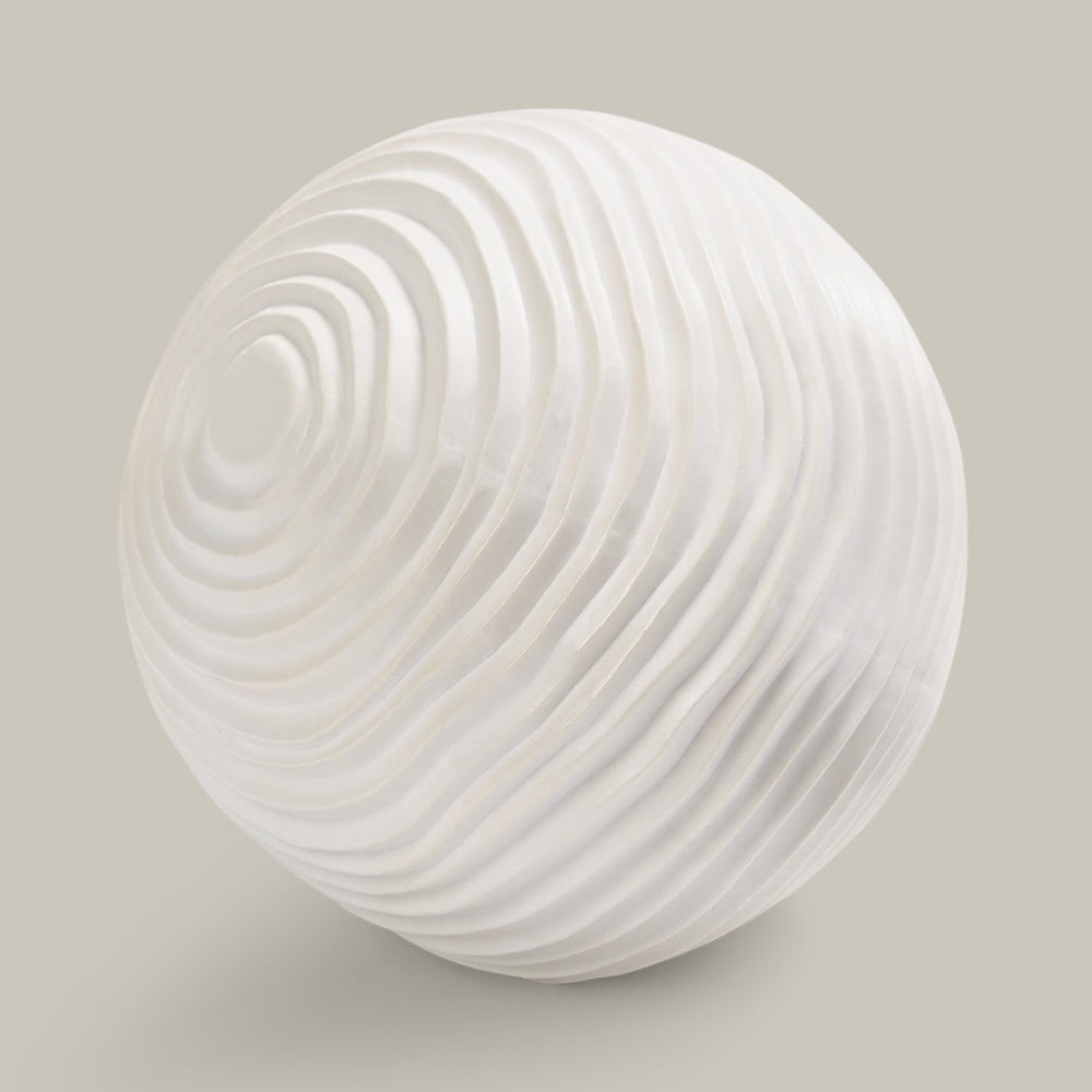Lemieux et Cie Varenne Sphere in matte ceramic with etched spiral surface, sculptural sphere shown on neutral studio backdrop.