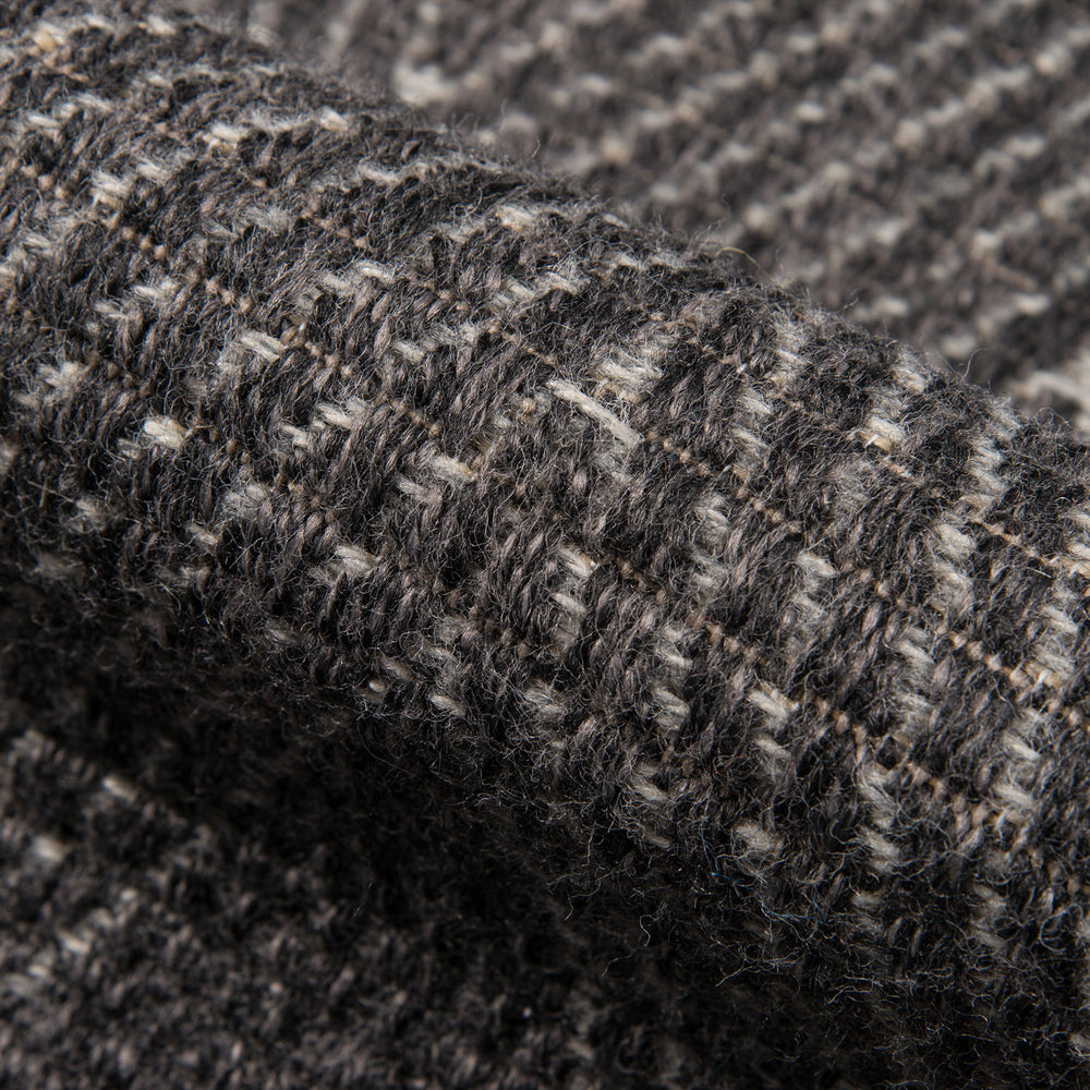 Lemieux et Cie Roanne Rug in charcoal and cream hand-knotted New Zealand wool, textured shaggy pile shown in close detail of check-pattern weave.