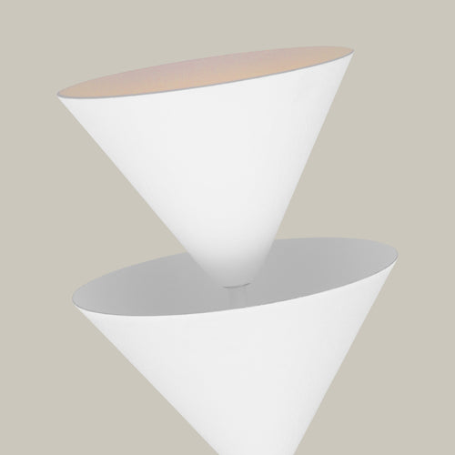 Lemieux et Cie Cornet Single Sconce, a handcrafted lighting fixture shown close up on the inverted cone plaster shade with soft light visible inside.