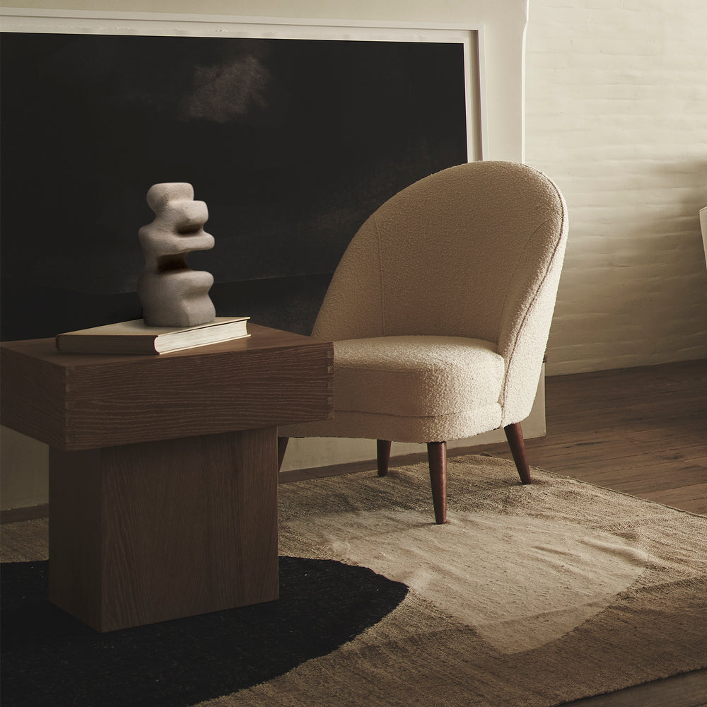 Lemieux et Cie Mguyon Sculpture in concrete, organic sculptural form with stacked cylindrical silhouette, styled on dark wood desk against black wall and neutral plaster walls.