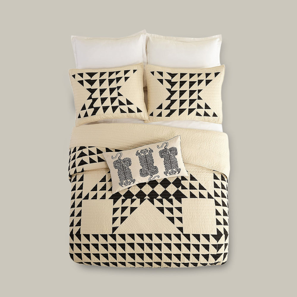 Lemieux et Cie Aubert Quilt Collection in ivory and black geometric pattern, quilted bedding with coordinating shams and pillow on neutral backdrop