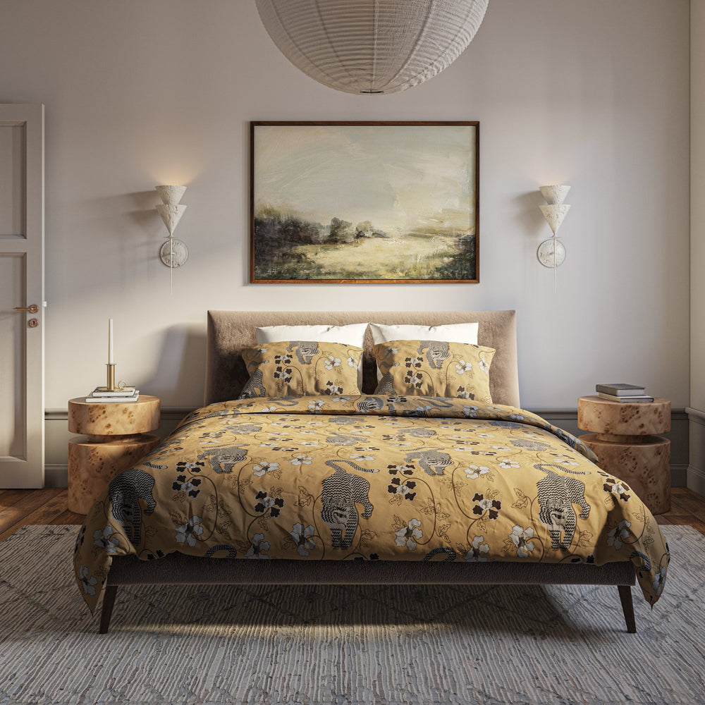 Lemieux et Cie Tiger 3-Piece Duvet Set in golden yellow with tiger and floral motif, cotton bedding styled in bedroom with neutral walls and wood floors.